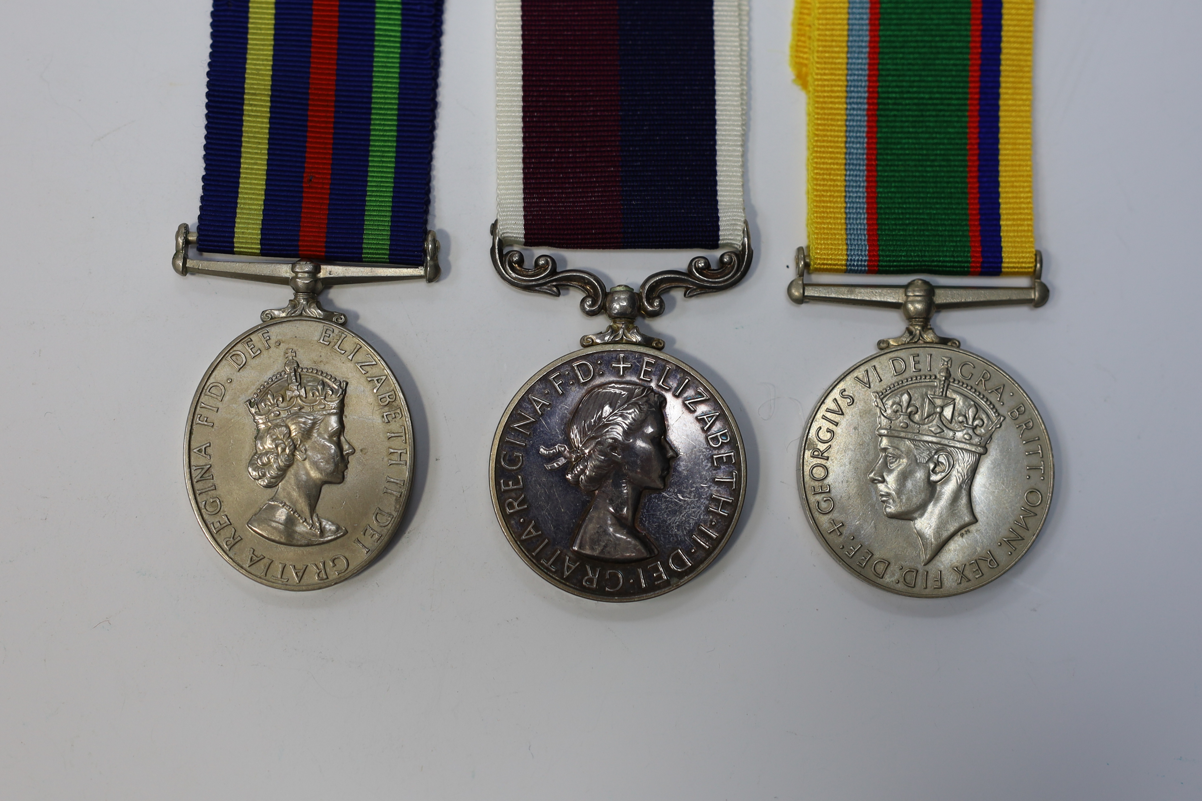 Three assorted service medals; GVI Cadet Forces medal to ACT. FG. Off. A. Liddell R.A.F.V.R (T); ERII Civil Defence Long Service medal unnamed; ERII RAFLSGC to E2418184 Cpl G R B Lowe RAF. Condition - fair to good.